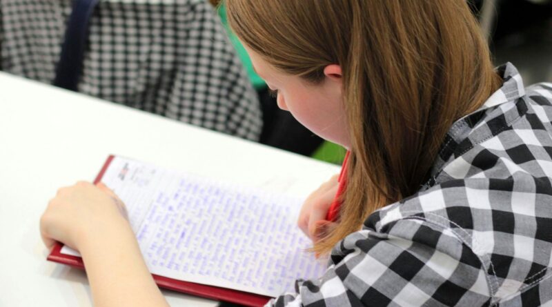 woman writing on paper